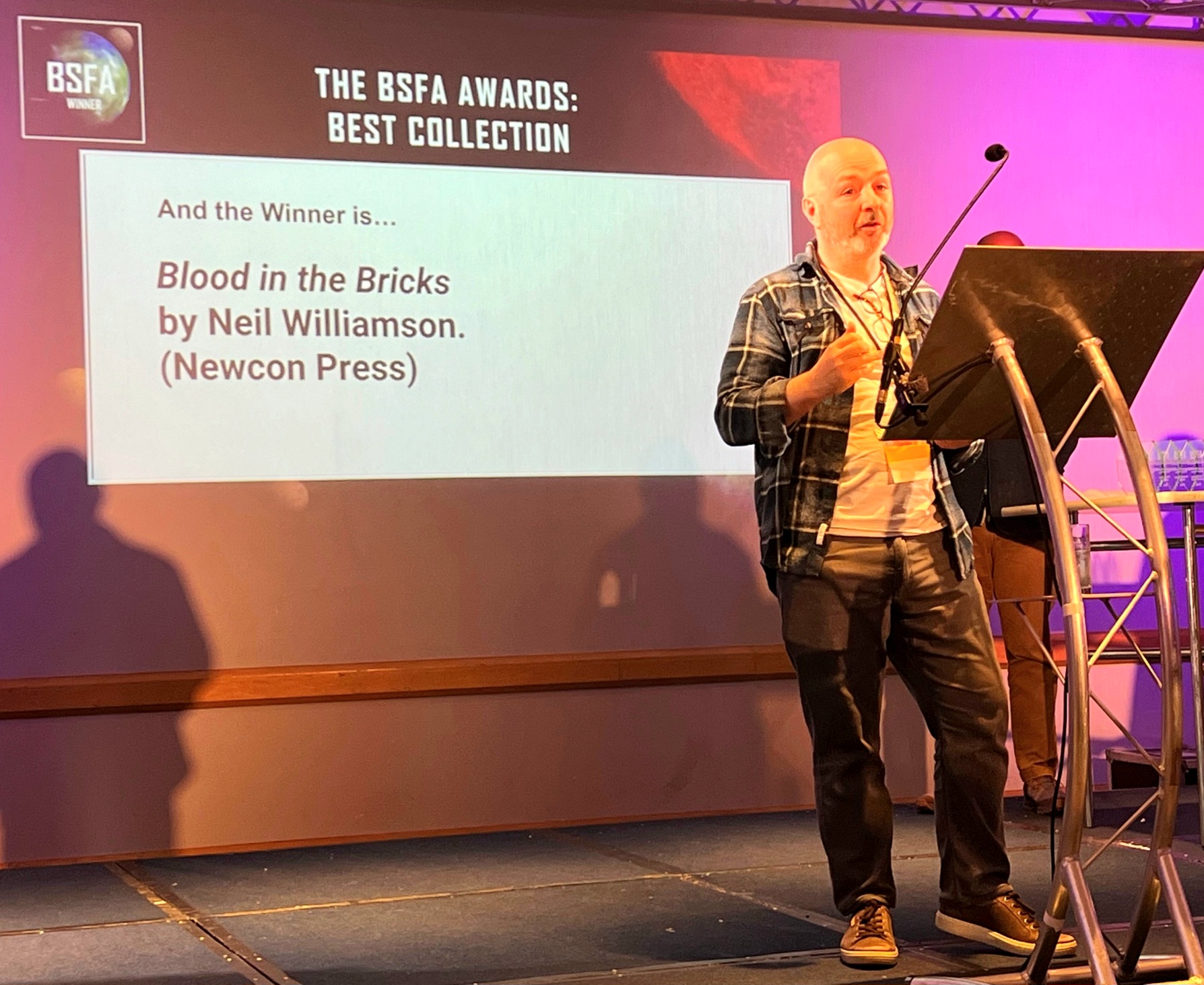 Neil Williamson accepting the 2025 BSFA award for Best Collection.